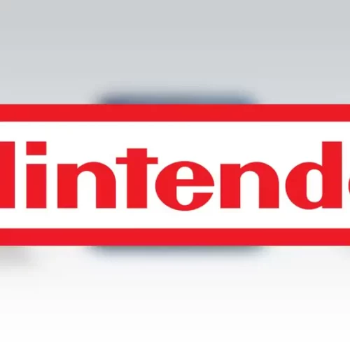 nintendo logo over blurred background of 3ds family of consoles